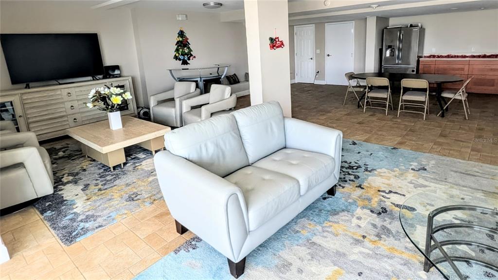 101 South Gulfstream Avenue, Unit 7E Sarasota, FL 34236 - Photo 39 of 40 a living room with furniture and a flat screen tv