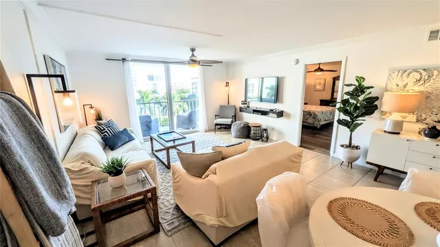a living room with furniture fireplace and a large window