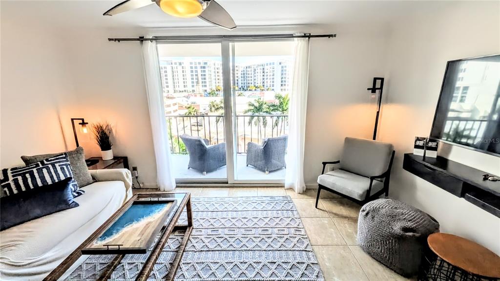 101 South Gulfstream Avenue, Unit 7E Sarasota, FL 34236 - Photo 10 of 40 a living room with furniture and a floor to ceiling window