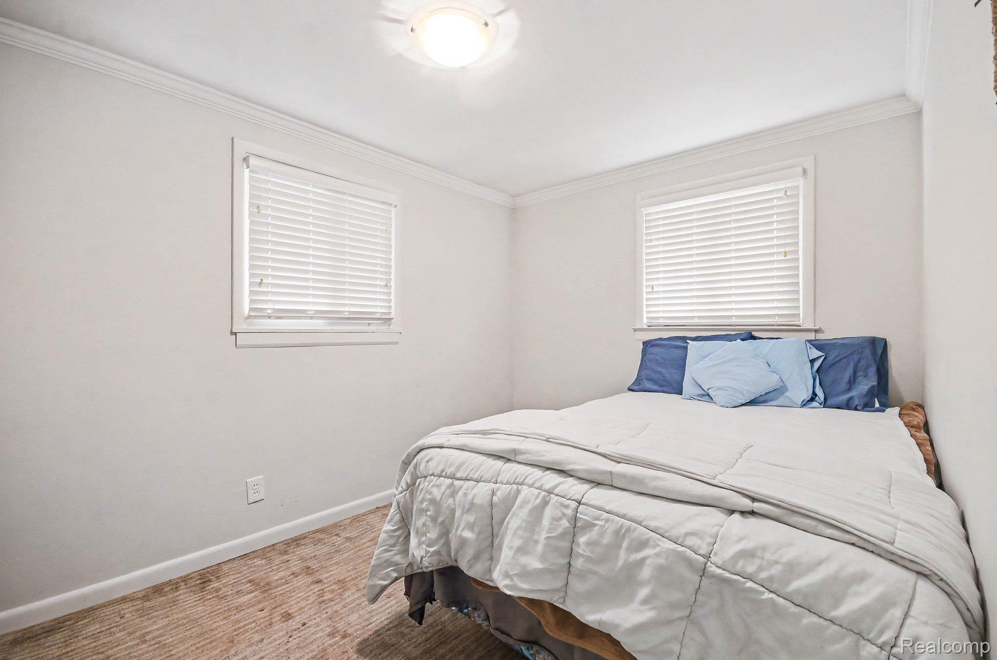 2126 Roslyn Road Grosse Pointe, MI 48236 - Photo 9 of 25 Carpeted bedroom featuring crown molding and baseboards