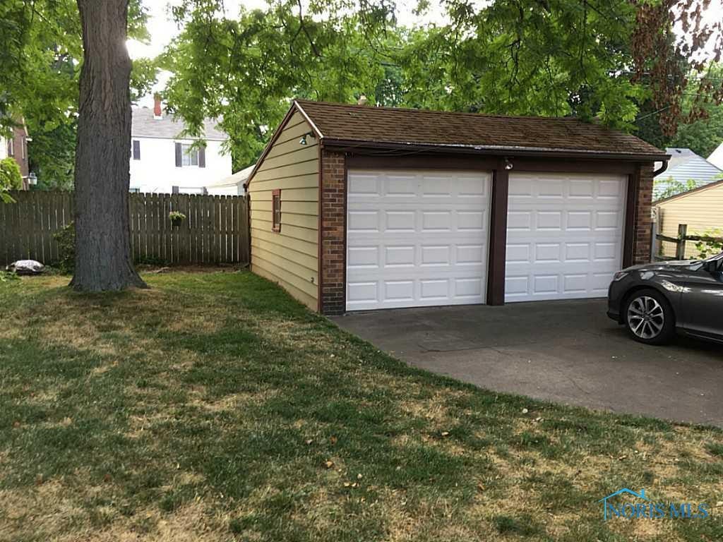 3811 Elmhurst Road Toledo, OH 43613 - Photo 19 of 19 Backyard. Two-car garage with brand new garage doors.