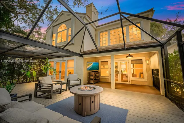 a view of a patio with a table and chairs under an umbrella
