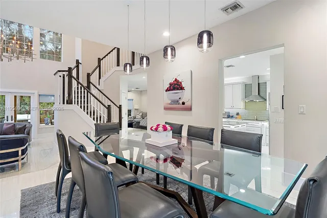 a dining room with furniture and wooden floor