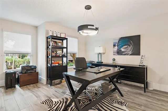 a workspace with furniture window and wooden floor