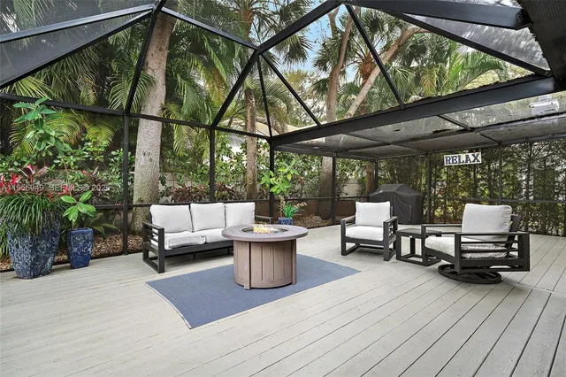 a view of living room with patio furniture and a potted plant