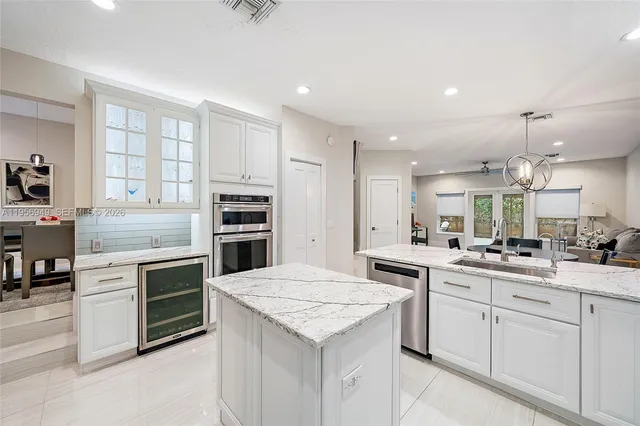 a kitchen with white cabinets and appliances