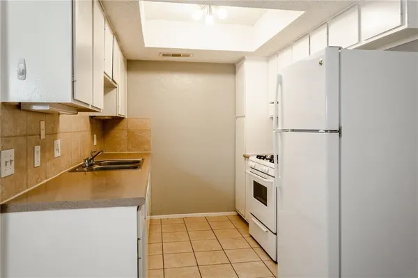 a kitchen with a refrigerator and a stove