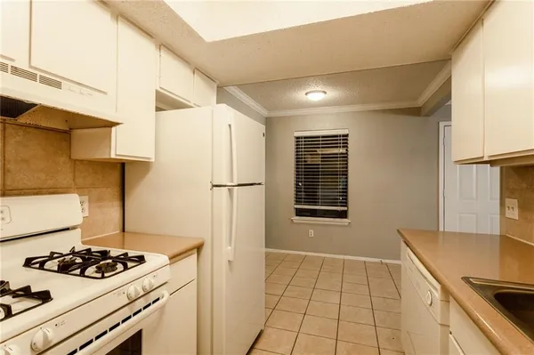 a kitchen with a stove and a refrigerator
