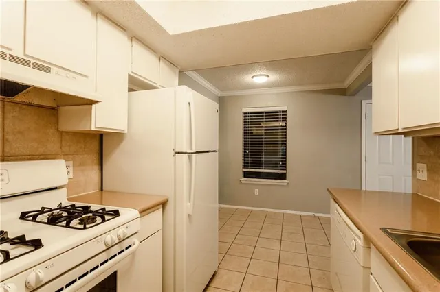 a kitchen with a stove and a refrigerator
