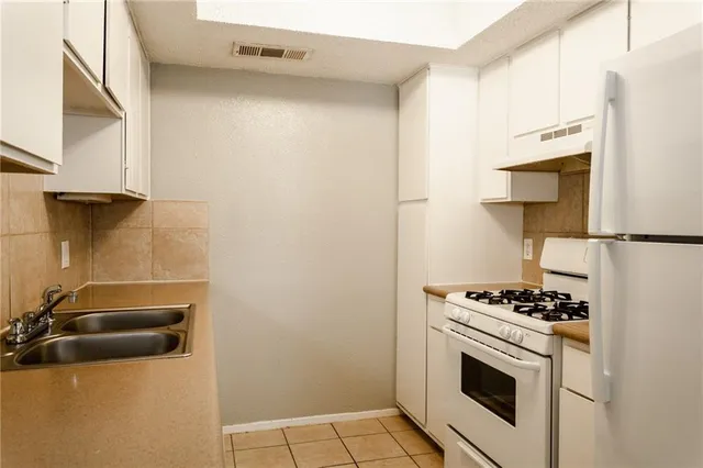 a kitchen with cabinets and appliances