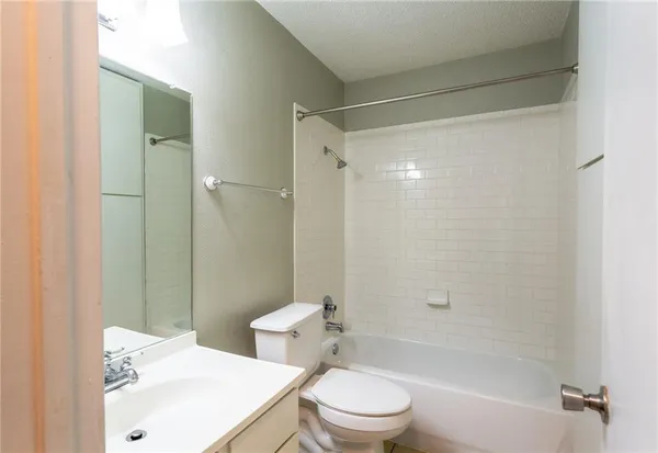 a bathroom with a sink mirror toilet and shower