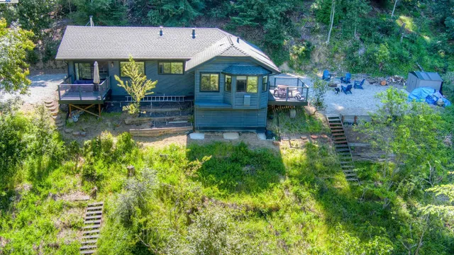 an aerial view of a house with swimming pool table and chairs