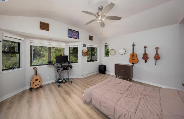 a view of a bedroom with workspace and a window