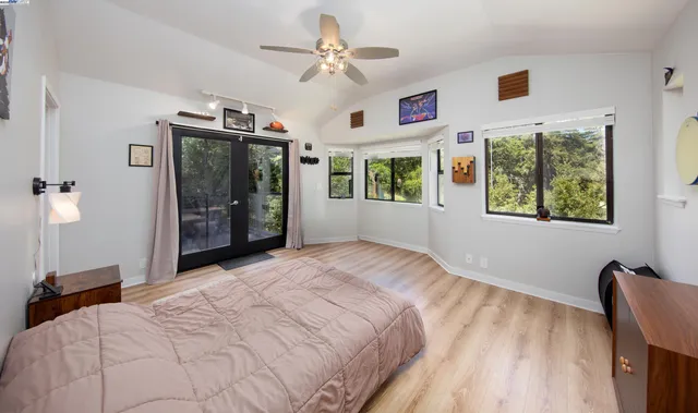 a bedroom with a large bed and a window