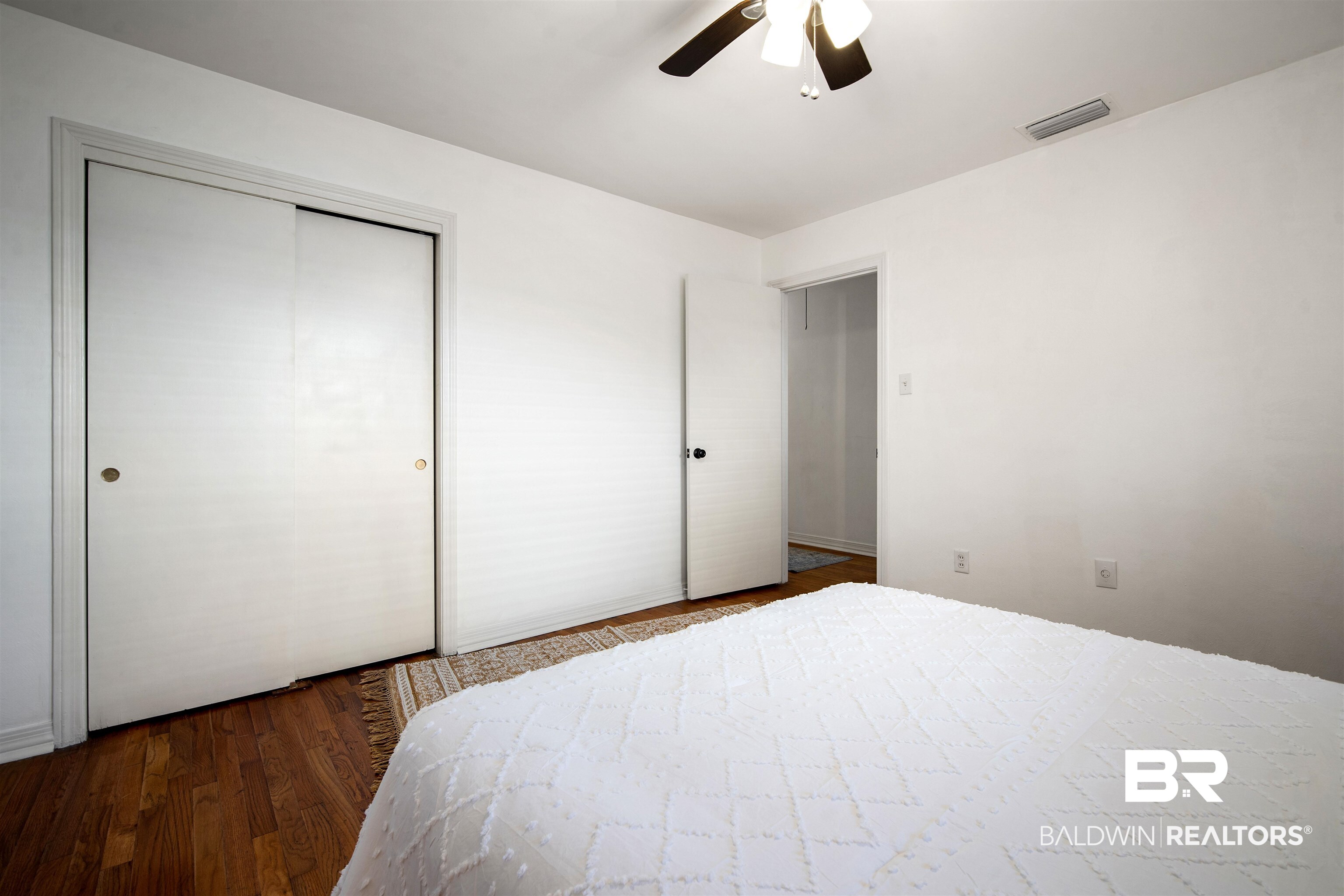 2615 Walton Avenue Mobile, AL 36606 - Photo 27 of 33 Bedroom featuring a closet, visible vents, ceiling fan, and wood finished floors