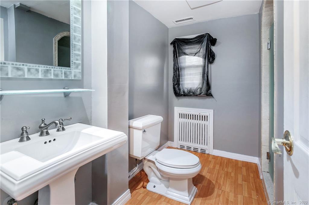 75 Van Buskirk Avenue, Unit 75 Stamford, CT 06902 - Photo 14 of 25 a bathroom with a toilet a sink and mirror