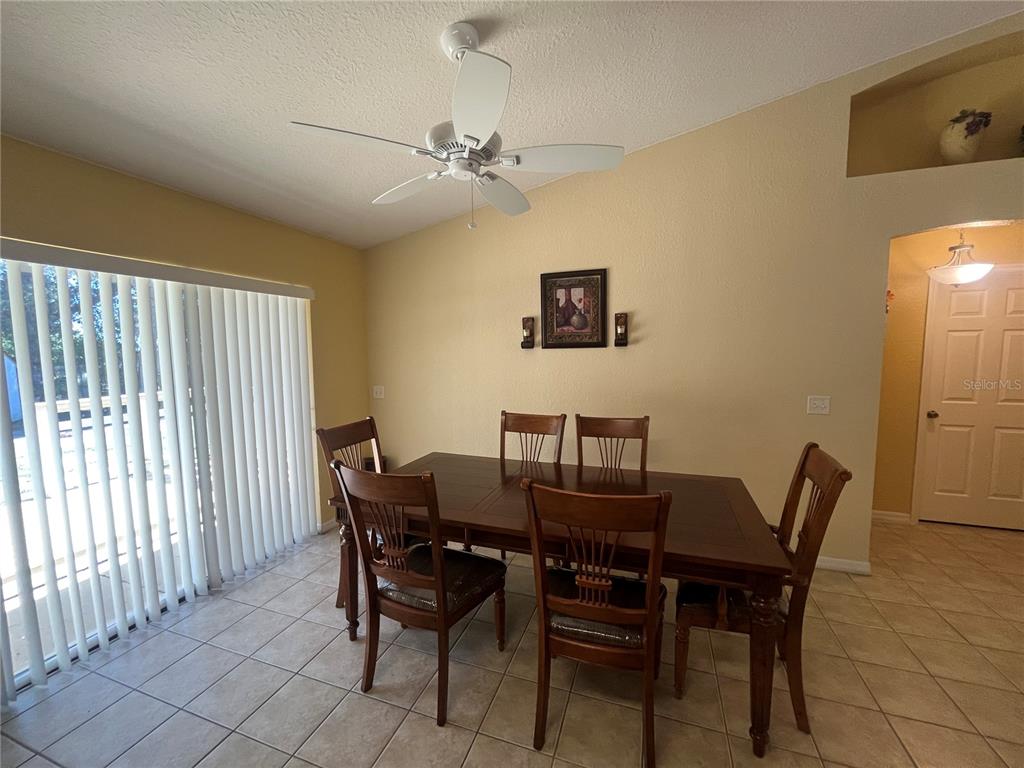 13615 Southeast 44th Terrace Summerfield, FL 34491 - Photo 10 of 26 a view of a dining room with furniture and chandelier