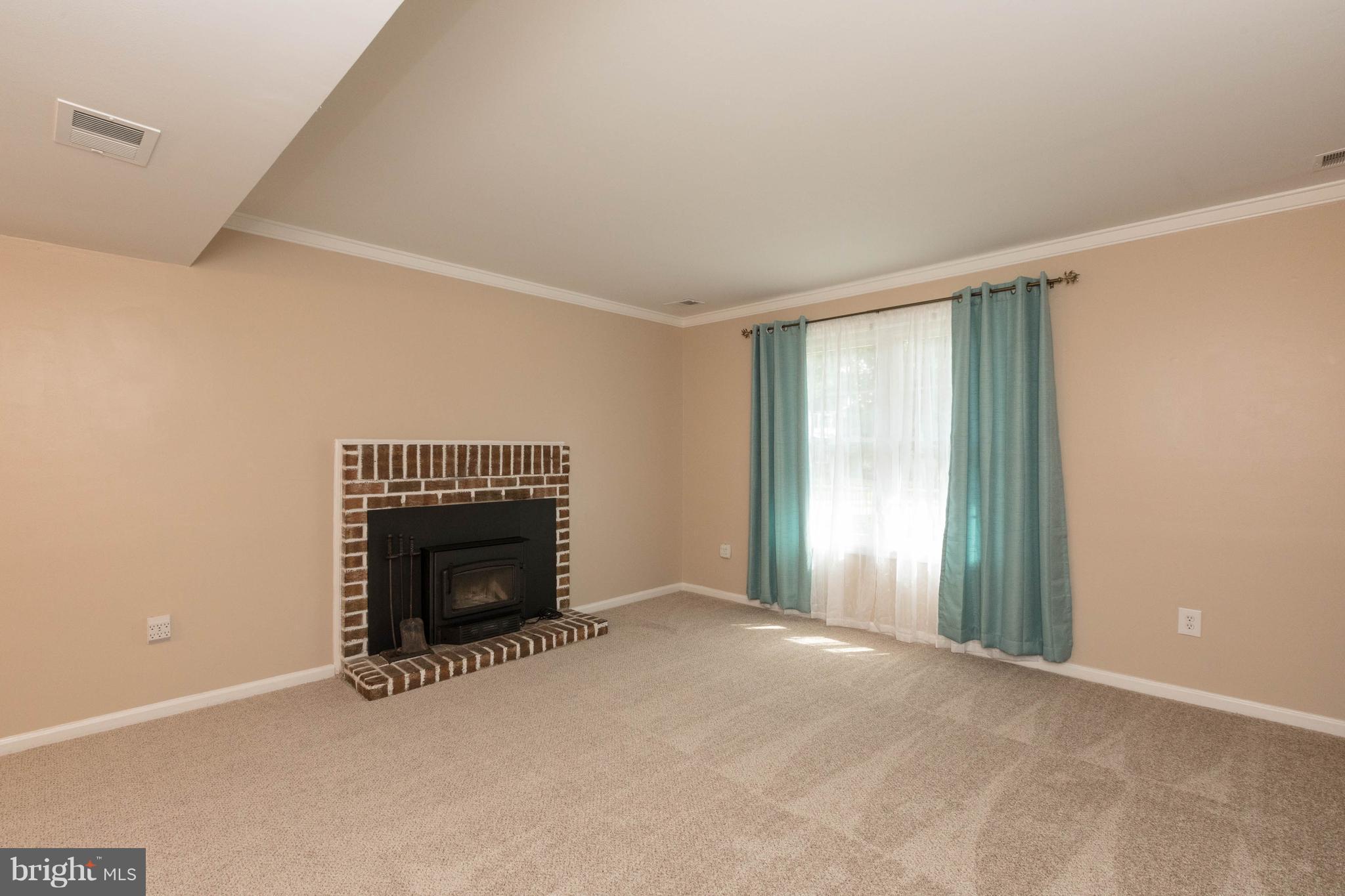 4555 Ryan Place Waldorf, MD 20602 - Photo 11 of 30 an empty room with windows and fireplace