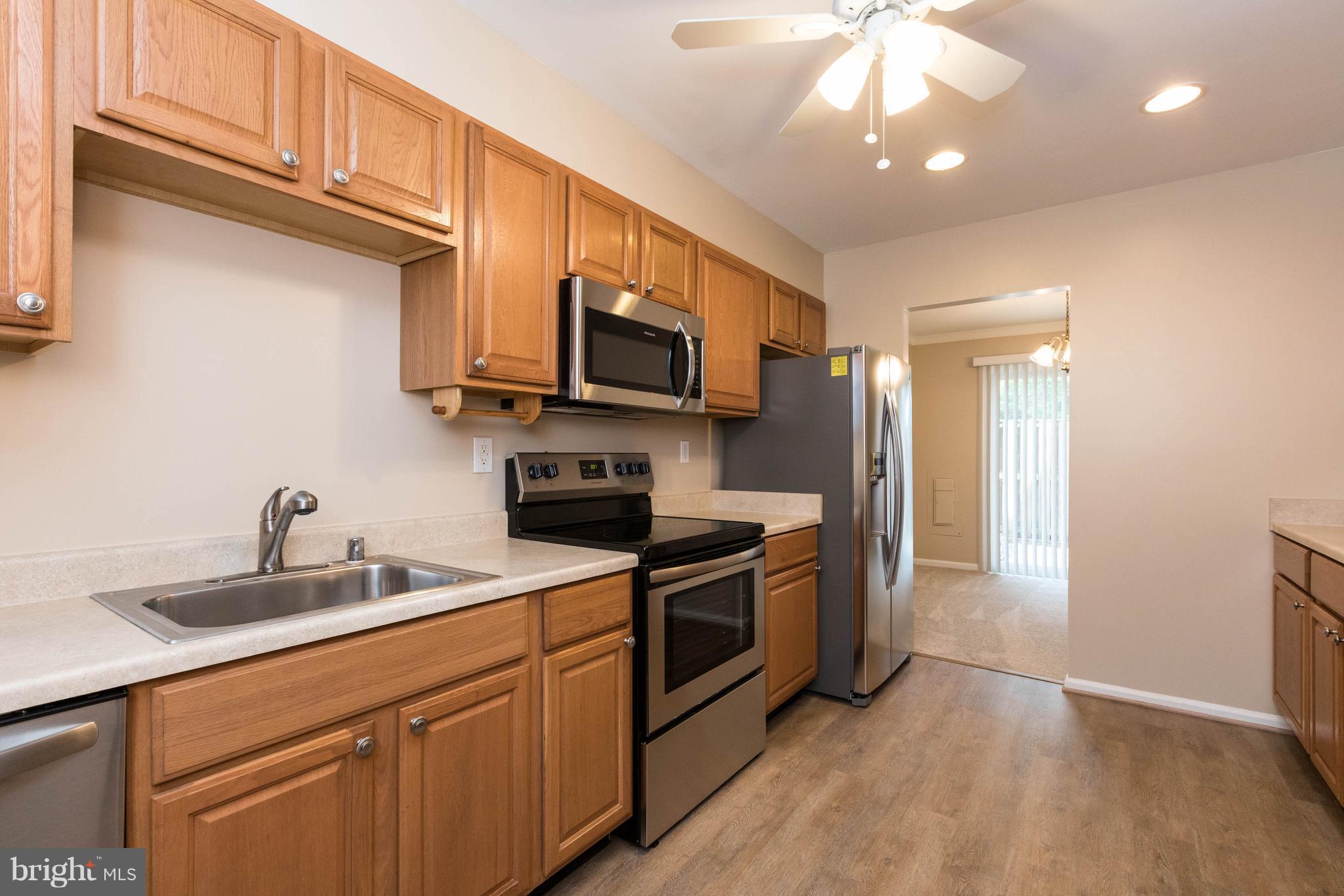 4555 Ryan Place Waldorf, MD 20602 - Photo 13 of 30 a kitchen with stainless steel appliances granite countertop a sink a stove and a refrigerator