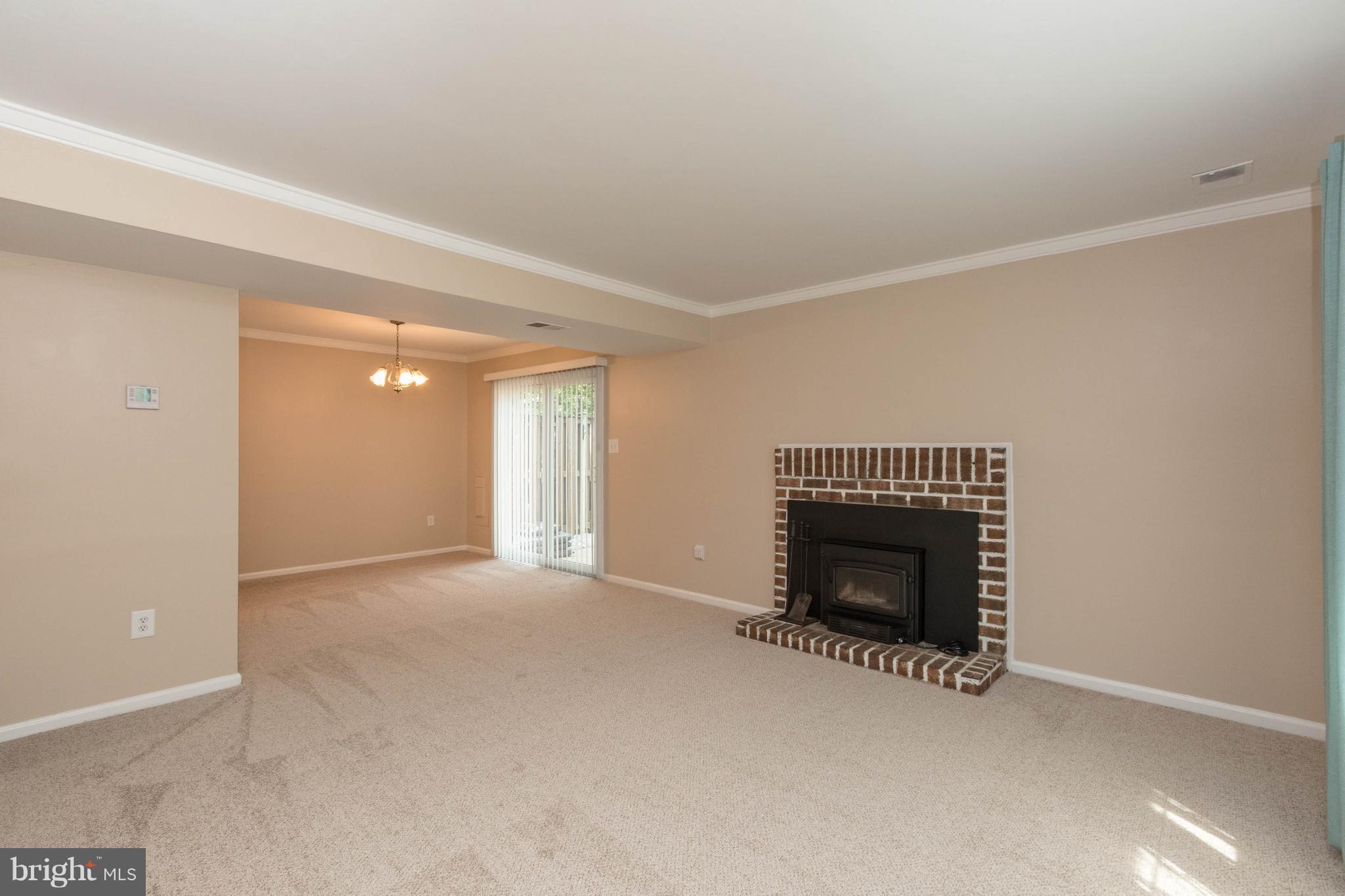 4555 Ryan Place Waldorf, MD 20602 - Photo 14 of 30 an empty room with a fireplace and window