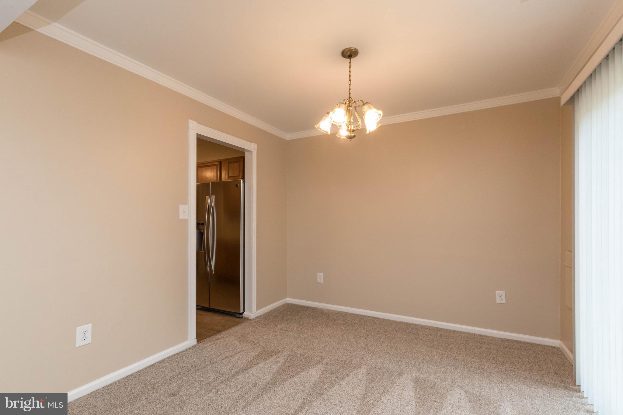 4555 Ryan Place Waldorf, MD 20602 - Photo 22 of 30 a view of an empty room with a chandelier fan