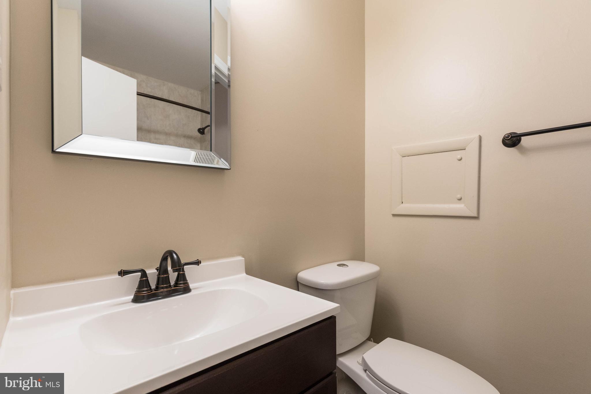 4555 Ryan Place Waldorf, MD 20602 - Photo 27 of 30 a bathroom with a sink a toilet and mirror