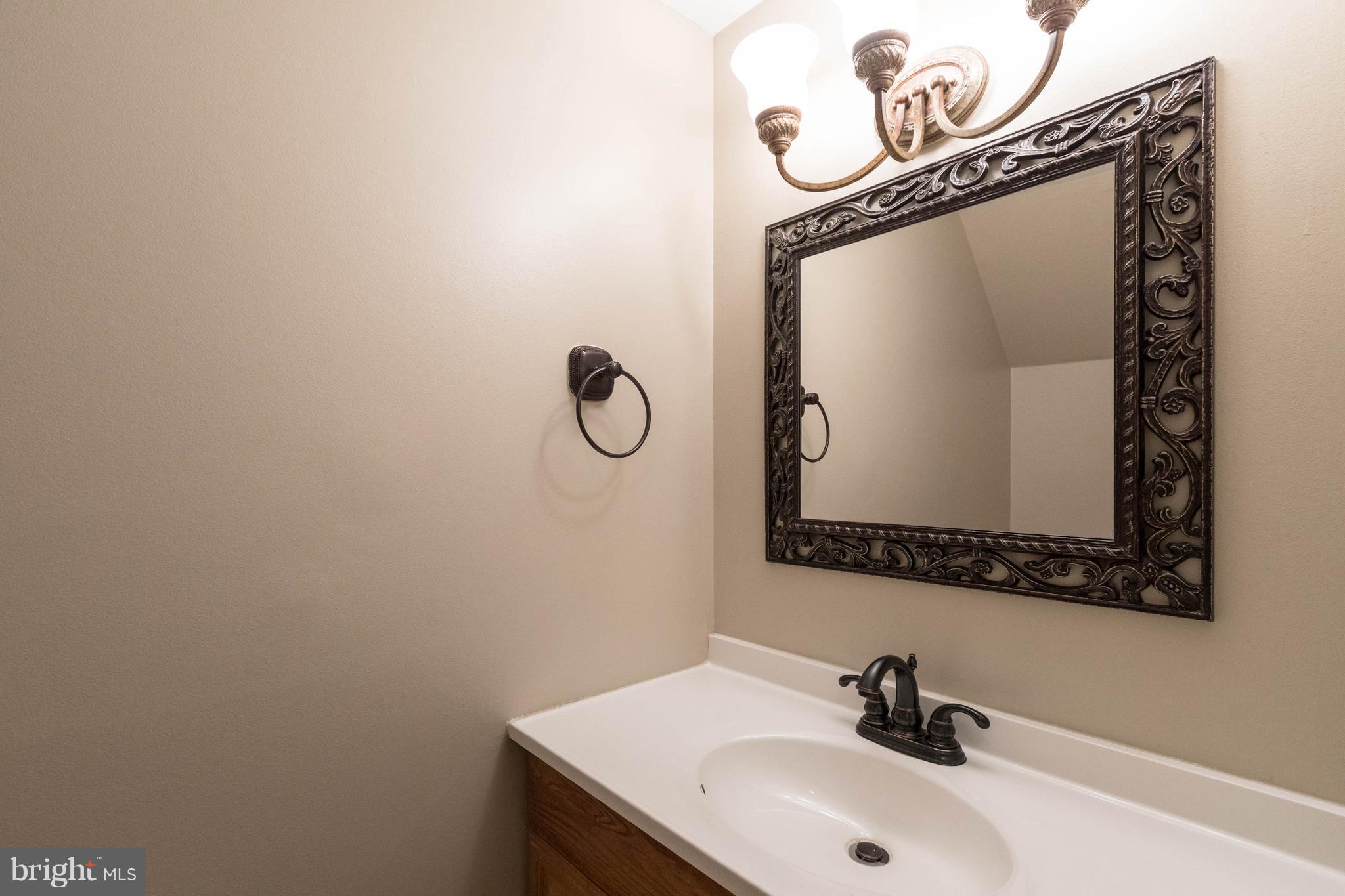 4555 Ryan Place Waldorf, MD 20602 - Photo 29 of 30 a bathroom with a sink and mirror