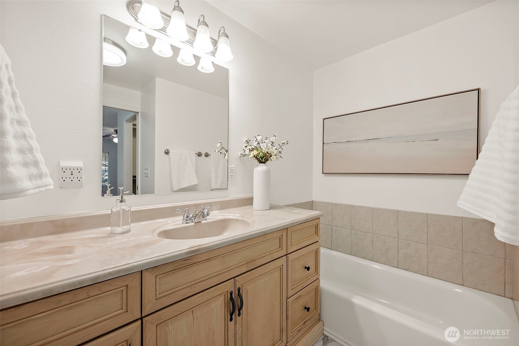 1117 17th Street Southwest Puyallup, WA 98371 - Photo 22 of 40 a bathroom with a sink a large mirror and a bathtub with a potted plant