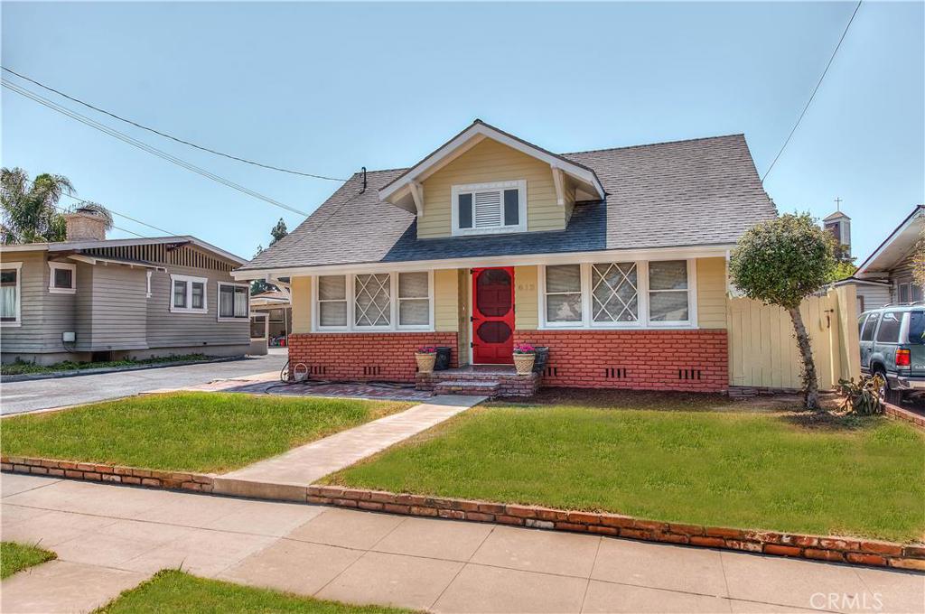 a view of a house with a yard and sitting area