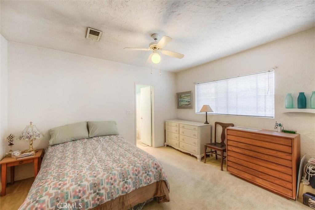 612 South Orange Street Orange, CA 92866 - Photo 12 of 44 a bedroom with a bed and a chandelier