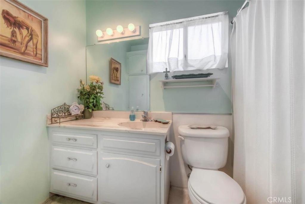 612 South Orange Street Orange, CA 92866 - Photo 14 of 44 a bathroom with a granite countertop toilet sink and mirror