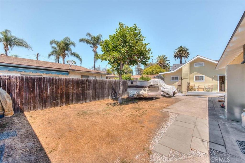 612 South Orange Street Orange, CA 92866 - Photo 35 of 44 a view of a white house with a small yard and wooden fence