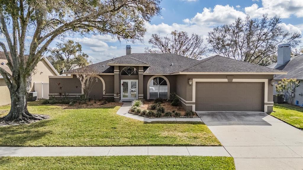 22848 Sterling Manor Loop Lutz, FL 33549 - Photo 1 of 1 a front view of a house with garden