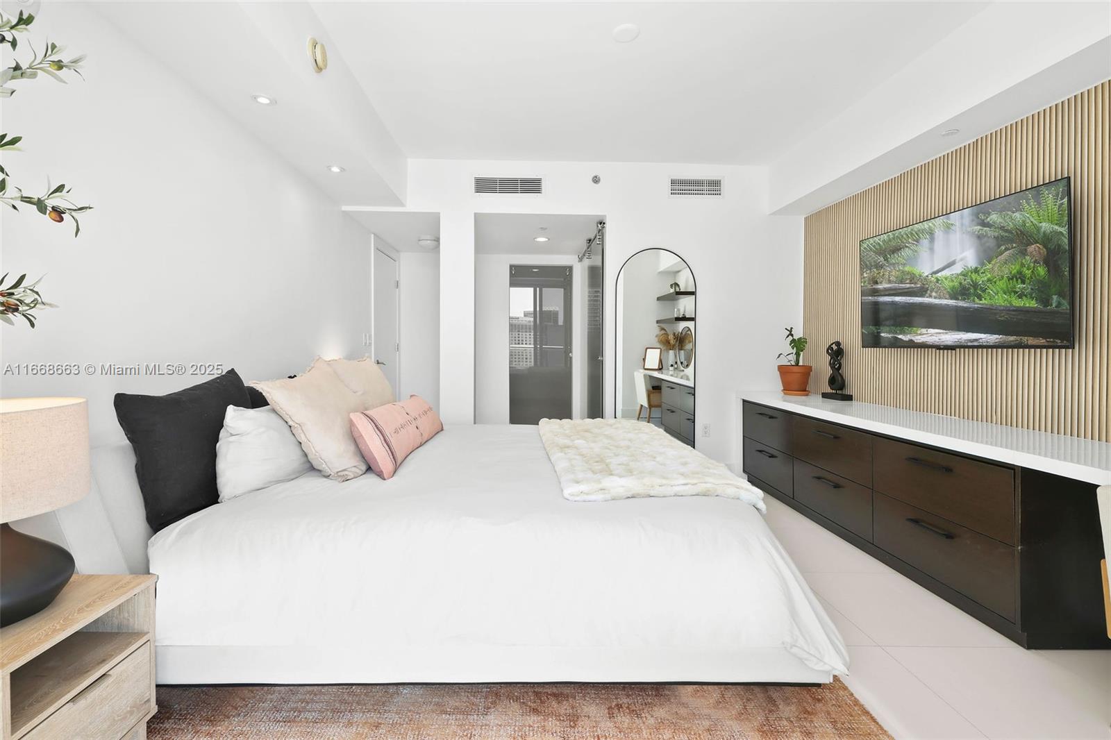 495 Brickell Avenue, Unit 2905 Miami, FL 33131 - Photo 14 of 53 a spacious bedroom with a bed and a flat screen tv