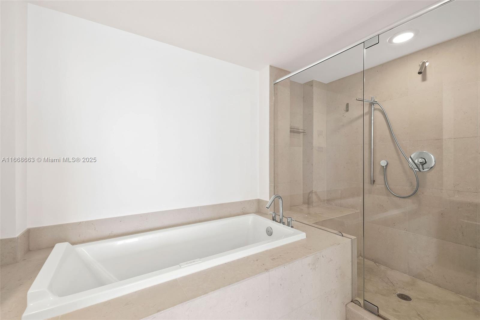 495 Brickell Avenue, Unit 2905 Miami, FL 33131 - Photo 17 of 53 a bathroom with a tub and a shower