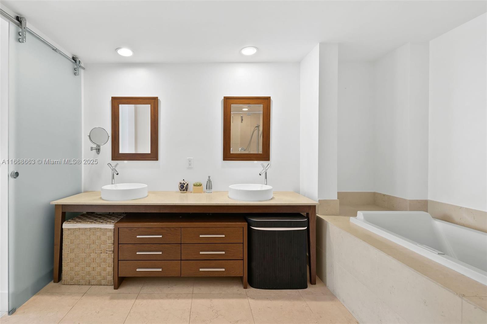 495 Brickell Avenue, Unit 2905 Miami, FL 33131 - Photo 18 of 53 a bathroom with a tub double vanity sink and mirror