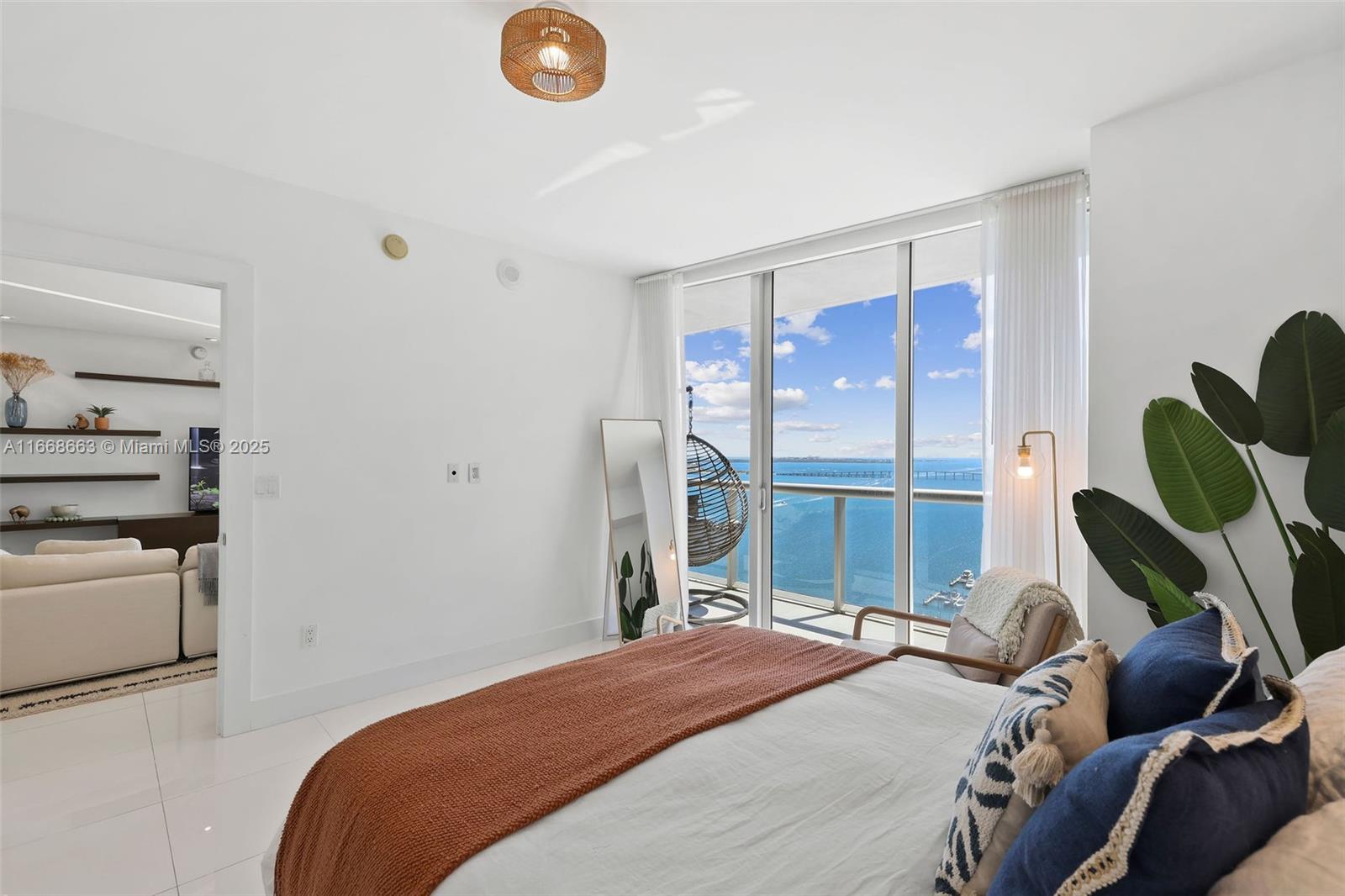495 Brickell Avenue, Unit 2905 Miami, FL 33131 - Photo 20 of 53 a bedroom with a bed and a chandelier