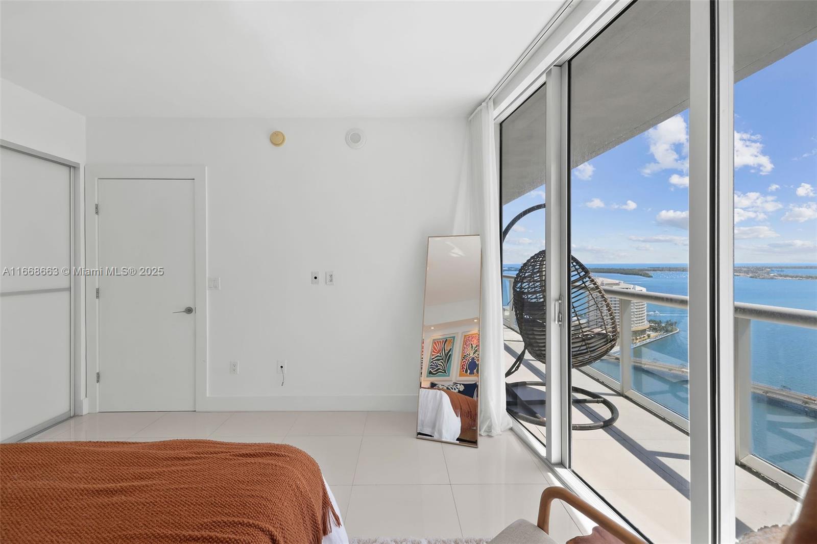 495 Brickell Avenue, Unit 2905 Miami, FL 33131 - Photo 24 of 53 a bedroom with a bed and glass door