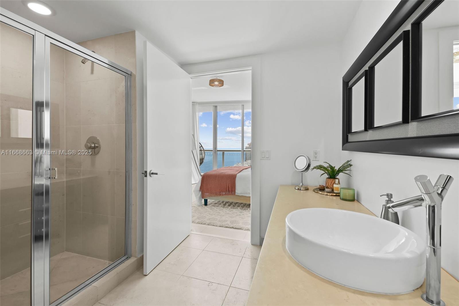 495 Brickell Avenue, Unit 2905 Miami, FL 33131 - Photo 25 of 53 a en suite spacious bathroom with a granite countertop tub shower and mirror