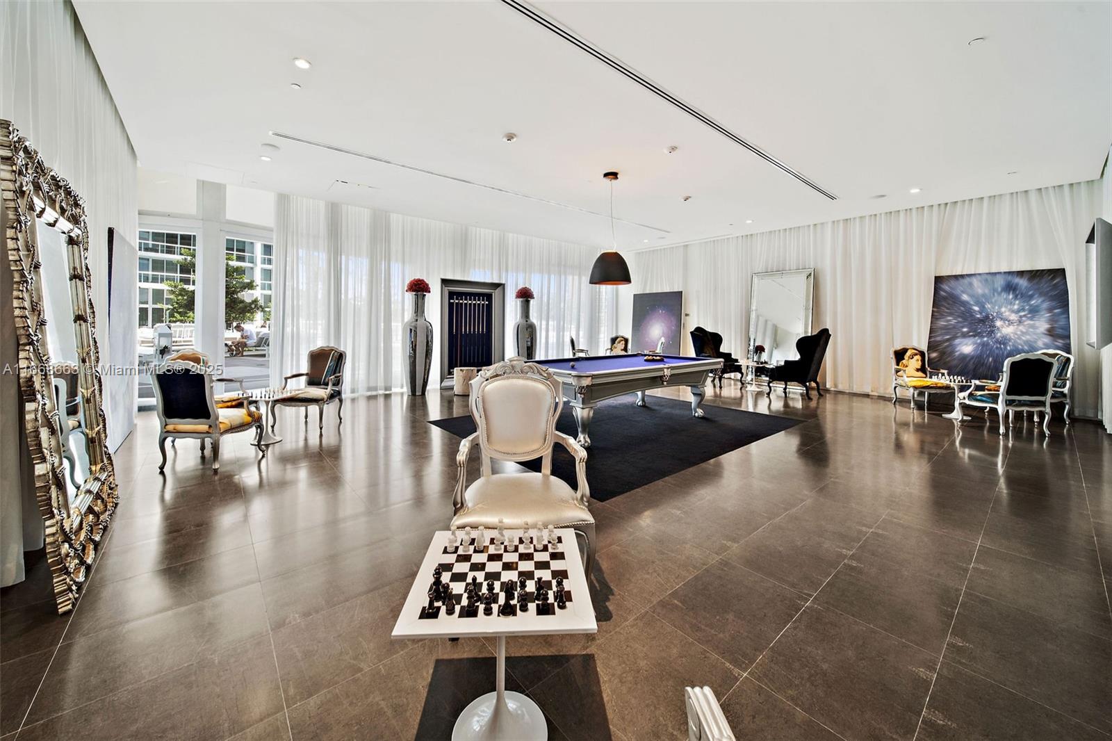 495 Brickell Avenue, Unit 2905 Miami, FL 33131 - Photo 38 of 53 a living room with furniture a rug kitchen view and a large window