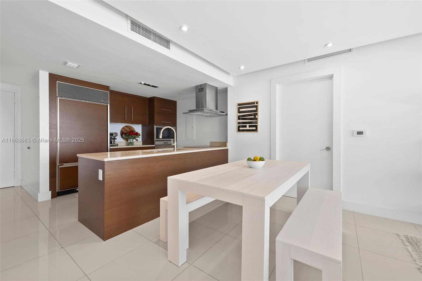 495 Brickell Avenue, Unit 2905 Miami, FL 33131 - Photo 8 of 53 a kitchen that has a cabinets and a table