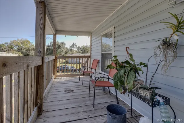 a view of a porch with wooden floor of a house