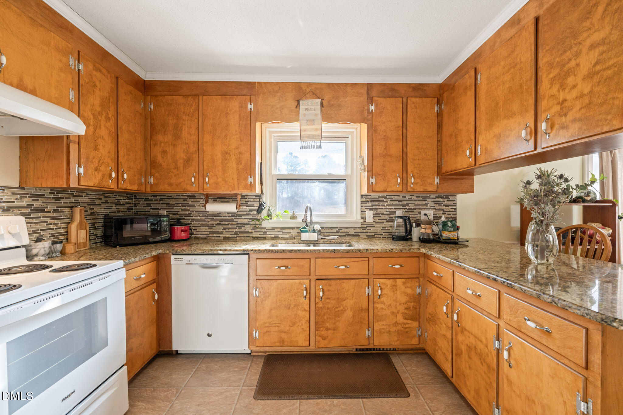 2802 Glover Road Durham, NC 27703 - Photo 13 of 44 a kitchen with a sink stove and cabinets