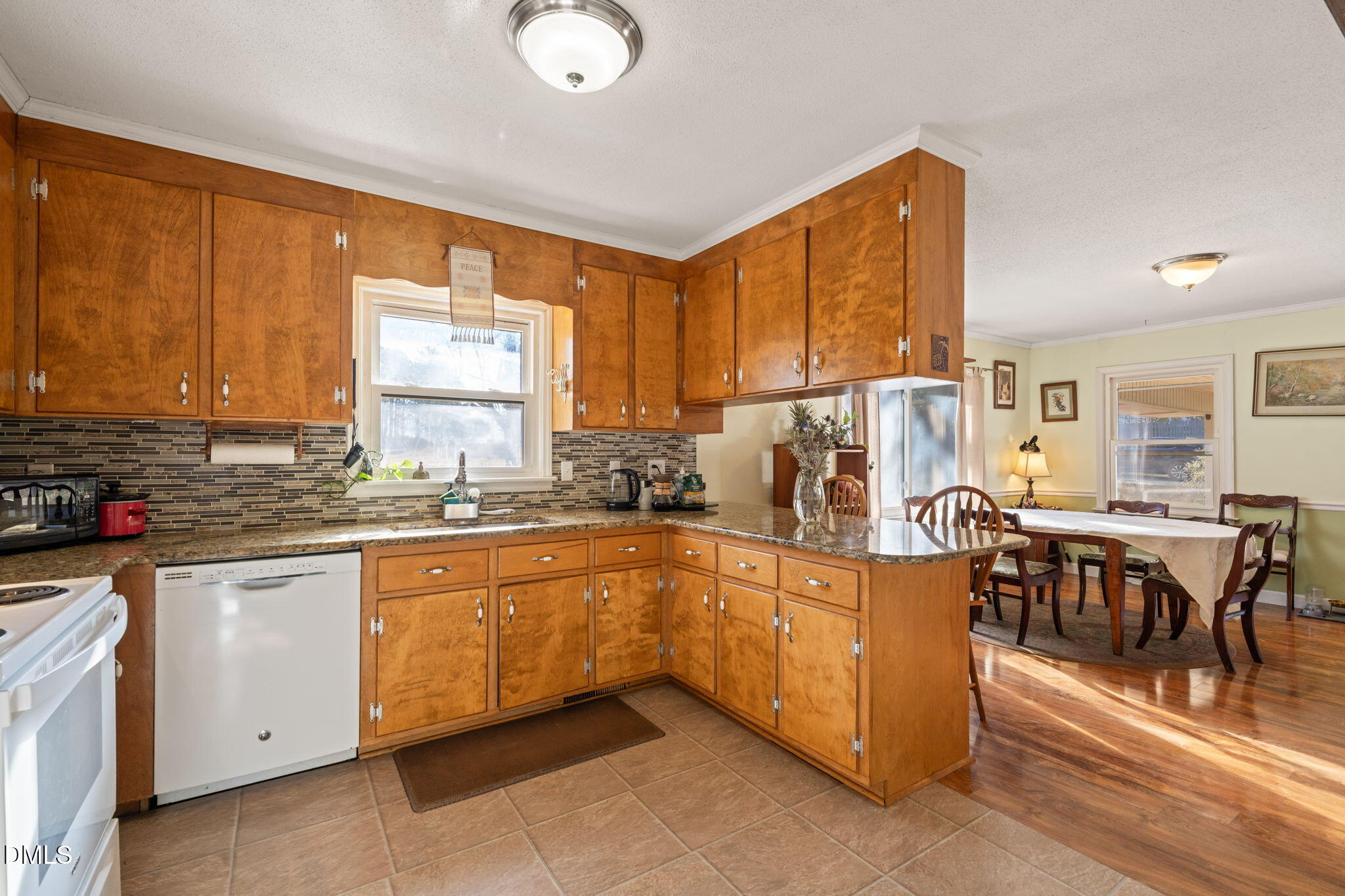 2802 Glover Road Durham, NC 27703 - Photo 14 of 44 a kitchen with stainless steel appliances granite countertop a stove top oven a sink dishwasher and cabinets with wooden floor