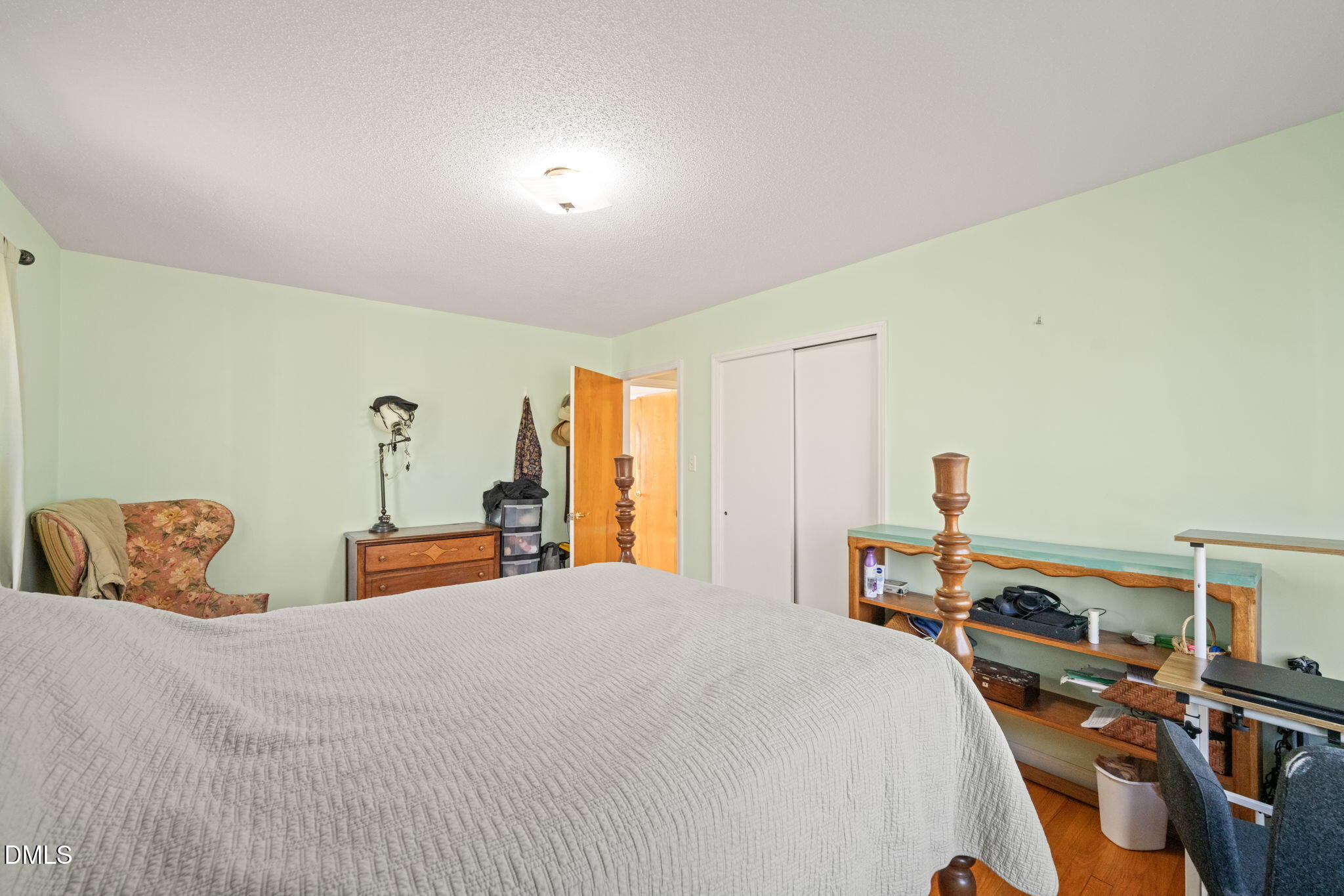 2802 Glover Road Durham, NC 27703 - Photo 17 of 44 a bedroom with a bed and a large mirror