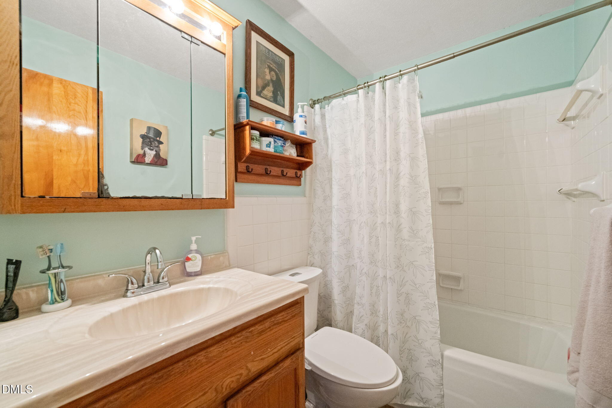 2802 Glover Road Durham, NC 27703 - Photo 18 of 44 a bathroom with a sink a toilet and shower
