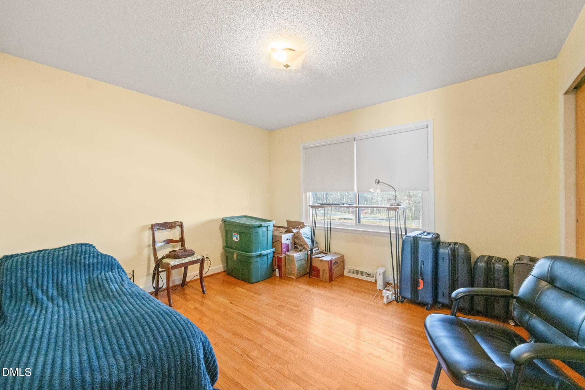 2802 Glover Road Durham, NC 27703 - Photo 20 of 44 a bedroom with furniture and a chandelier