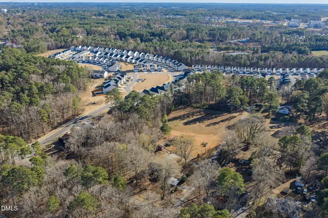 an aerial view of mountain with residential house and lake view