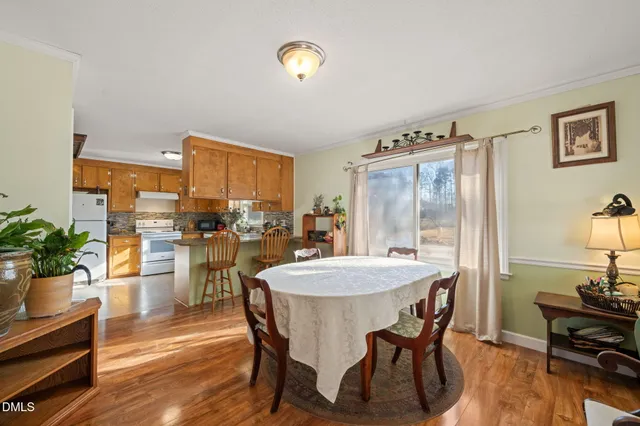 a view of a dining room with furniture and a chandelier