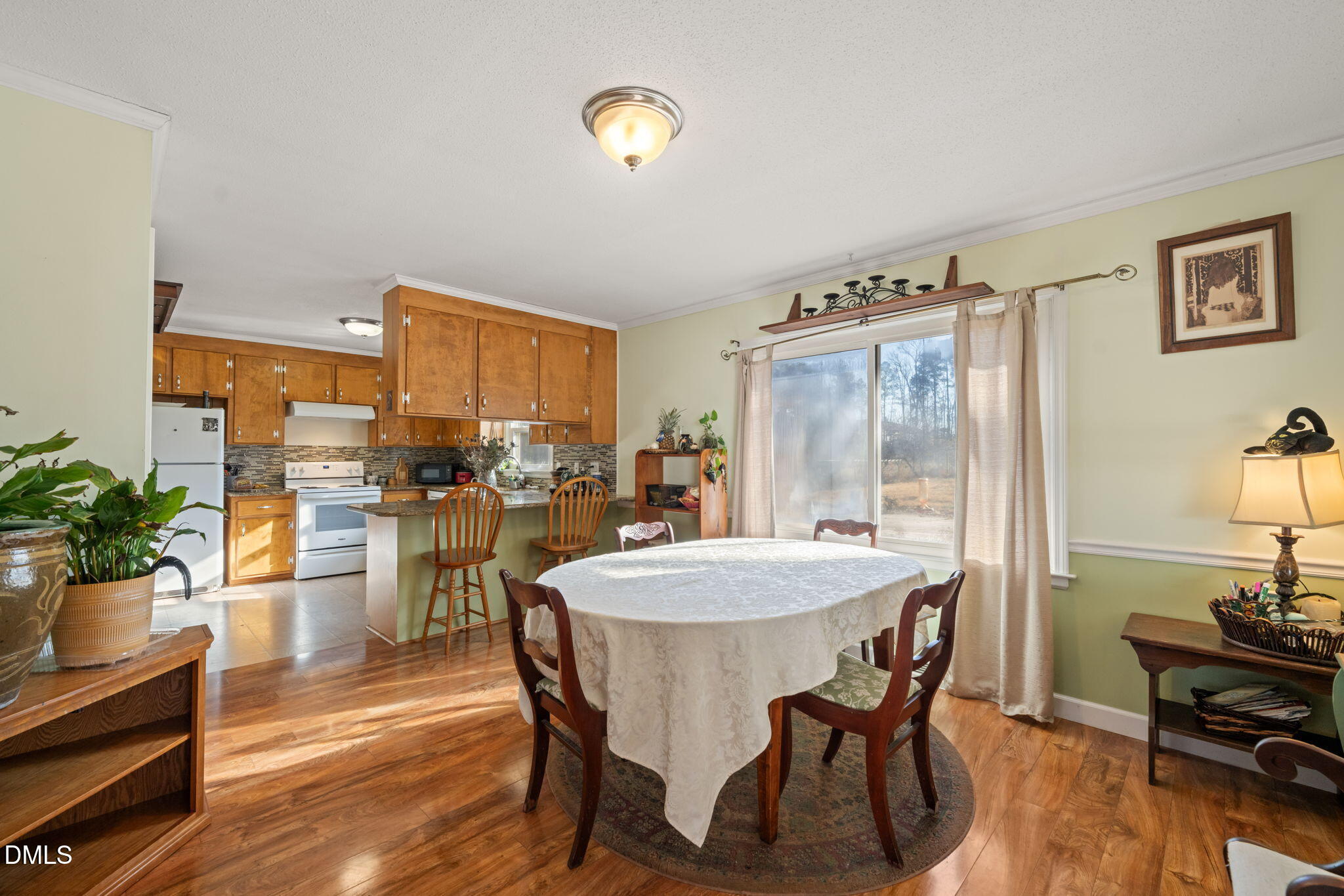 2802 Glover Road Durham, NC 27703 - Photo 10 of 44 a view of a dining room with furniture and a chandelier